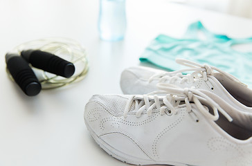 Image showing close up of sportswear, skipping rope and bottle