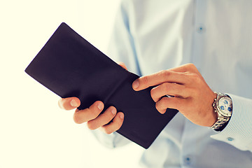 Image showing close up of businessman hands holding open wallet