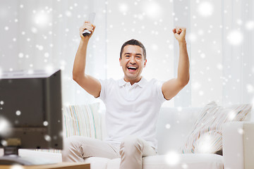 Image showing smiling man watching sports at home