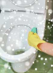 Image showing close up of hand with detergent cleaning toilet