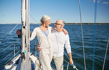 Image showing senior couple hugging on sail boat or yacht in sea