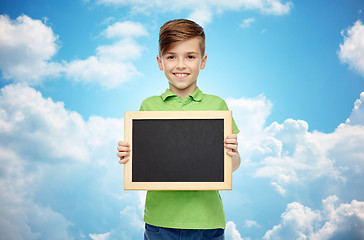 Image showing happy boy in t-shirt holding blank chalk board