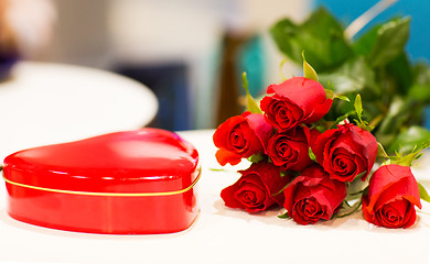 Image showing close up of chocolate box and red rose flowers