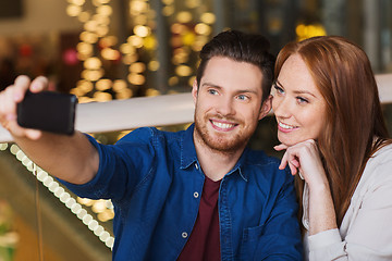 Image showing couple taking selfie by smartphone at restaurant