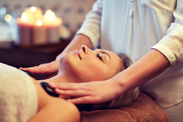 Image showing close up of woman having hot stone massage in spa