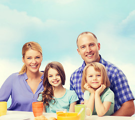 Image showing happy family with two kids with having breakfast