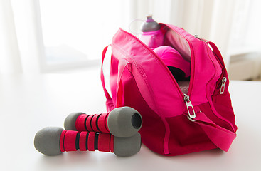 Image showing close up of sports stuff in bag and dumbbells