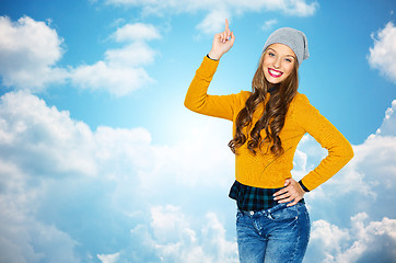 Image showing happy young woman or teen girl pointing finger up