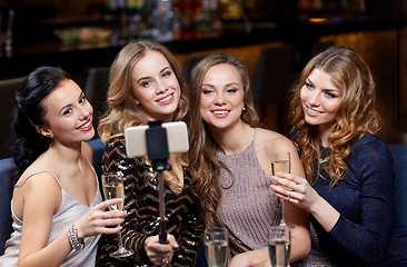 Image showing women with smartphone taking selfie at night club