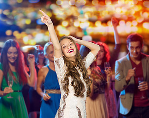 Image showing happy young woman dancing at night club