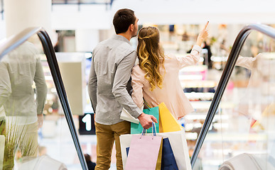 Image showing happy young couple with shopping bags in mall