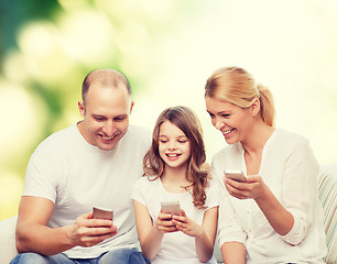 Image showing happy family with smartphones