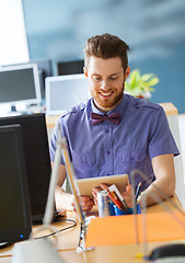 Image showing happy creative male office worker with tablet pc