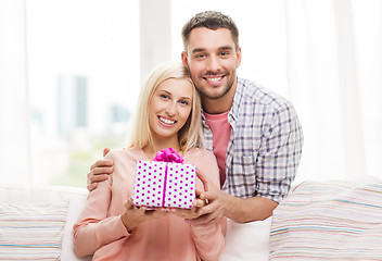 Image showing happy man giving woman gift box at home