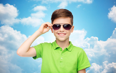 Image showing smiling boy in sunglasses and green polo t-shirt