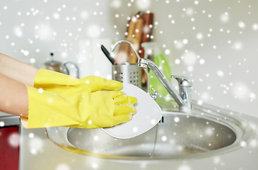 Image showing close up of woman hands washing dishes in kitchen