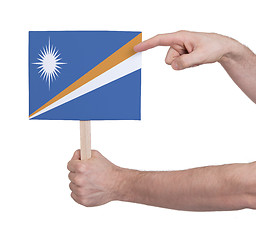 Image showing Hand holding small card - Flag of Marshall Islands