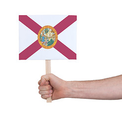 Image showing Hand holding small card - Flag of Florida