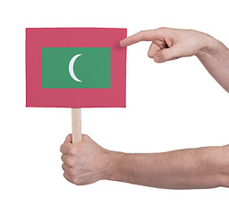 Image showing Hand holding small card - Flag of Maldives