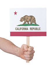 Image showing Hand holding small card - Flag of California