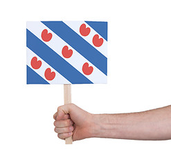 Image showing Hand holding small card - Flag of Friesland