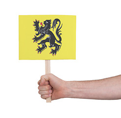 Image showing Hand holding small card - Flag of Flanders