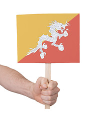 Image showing Hand holding small card - Flag of Bhutan