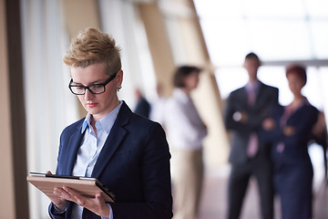 Image showing business woman  at office with tablet  in front  as team leader