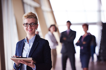 Image showing business woman  at office with tablet  in front  as team leader