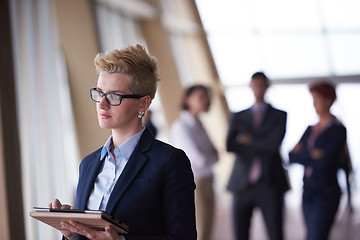 Image showing business woman  at office with tablet  in front  as team leader