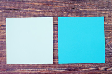 Image showing color paper on wooden background