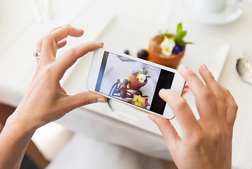 Image showing close up of woman picturing food by smartphone