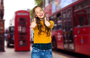 Image showing happy young woman or teen girl showing thumbs up