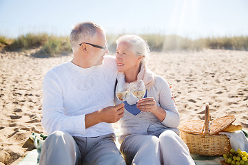 Image showing happy senior couple talking on summer beach