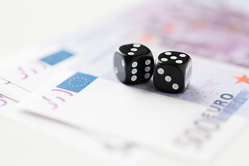 Image showing close up of black dice and euro cash money