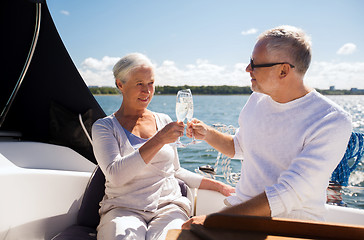 Image showing senior couple clinking glasses on boat or yacht