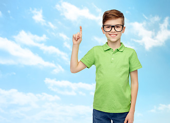 Image showing happy boy in eyeglasses pointing finger up