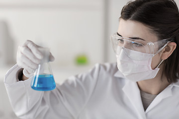 Image showing close up of scientist with flask making test