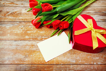 Image showing close up of red tulips, letter and chocolate box