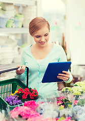 Image showing woman with tablet pc and basket at flower shop