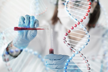 Image showing close up of scientist with tube making test in lab