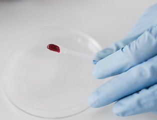 Image showing close up of scientist with blood sample in lab
