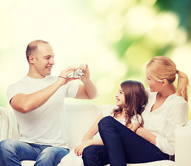 Image showing happy family with camera at home