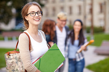 Image showing happy teenage students with school folders