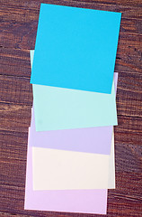 Image showing color paper on wooden background