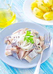 Image showing herring with onion on blue plate