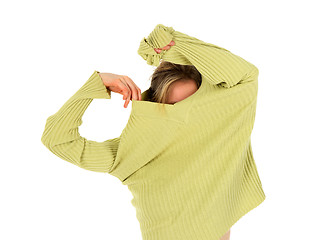 Image showing Funny girl takes off a green sweater