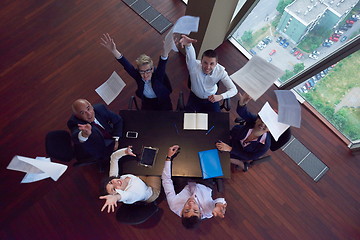 Image showing top view of business people group throwing dociments in air