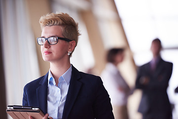 Image showing business woman  at office with tablet  in front  as team leader