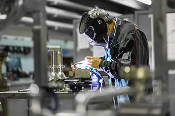 Image showing Industrial worker welding in metal factory.